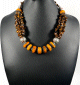 Collier ethnique artisanal avec pierres orange et marron agrémenté de breloques et d'armatures argentées Collier ethnique artisanal avec pierres orange et marron agremente de breloques et d'armatures argentees