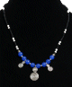 Collier ethnique artisanal boules bleues agencé de perles noires et blanches avec agréments argentés et breloques spirales Collier ethnique artisanal boules bleues agence de perles noires et blanches avec agrements argentes et breloques spirales